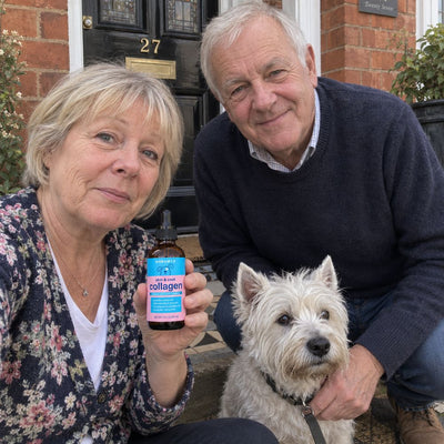 Retired couple with their Westie on the front step